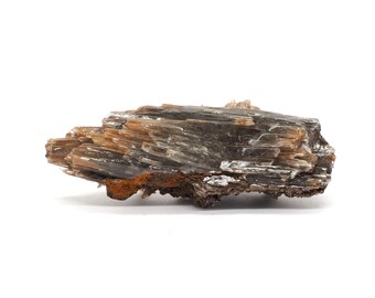 May include: A layered mineral specimen with a mix of brown, tan, and silver tones. The rock formation has a rough, textured surface and a dark brown base with orange hues. The mineral is set against a plain white background.