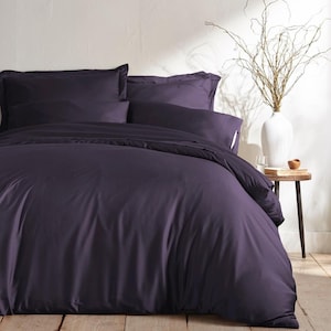 May include: A deep purple duvet cover with matching pillowcases. The bedding is made of a soft, smooth fabric and is wrinkle-resistant.