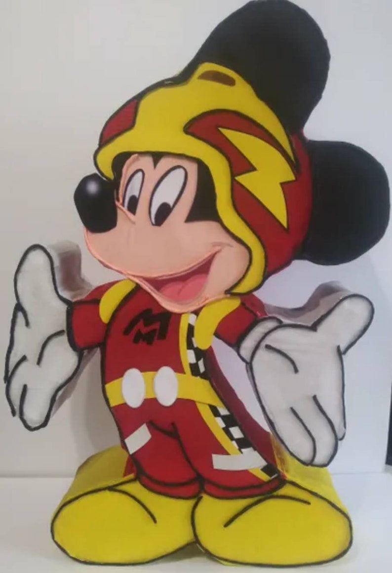 May include: A red and yellow Mickey Mouse pinata wearing a racing helmet with a lightning bolt design. The pinata is standing on a yellow base.