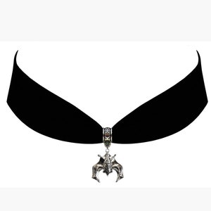 May include: A black velvet choker necklace with a silver bat pendant.