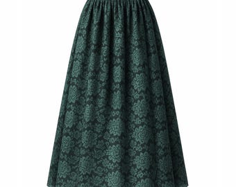 May include: A dark green, floor-length skirt with a floral pattern. The skirt has a gathered waistband and a full, flowing silhouette. The floral design is a lighter shade of green, creating a subtle contrast against the darker background.