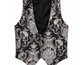 May include: A sleeveless vest featuring a black and silver damask pattern. The garment has a deep V-neckline, a solid black interior lining, and three circular metallic buttons with an embossed design along the front closure.