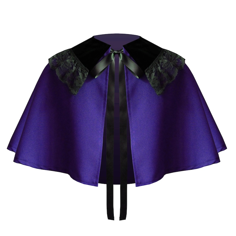 May include: A deep purple capelet featuring a black velvet collar with black lace trim along the edges. The garment is secured at the neckline with a black satin ribbon tie that hangs down the front, creating a structured and flared silhouette.