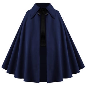 May include: A deep navy blue cape featuring a wide, pointed collar and a black ribbon tie closure at the neckline. The garment has a flared, A-line silhouette that drapes in soft, vertical folds from the shoulders down to the hemline.