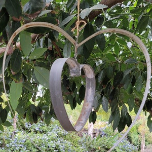 Unique hand bent heart made from authentic reclaimed wine/whiskey barrel bands can be hung from any item at your house or yard.