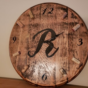 Wall mount clock made from authentic bourbon/whiskey/wine barrel lid.