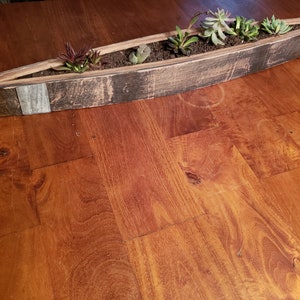 Wine/whiskey barrel wood planter made from authentic reclaimed barrel wood.
