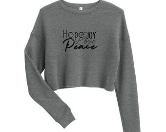 May include: A gray cropped sweatshirt with the text "Hope Joy Love Peace" in black lettering.