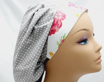 May include: A gray and white patterned surgical scrub hat with a floral print on the inside. The hat has a black tie.