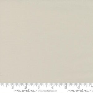 May include: A solid, off-white fabric with a subtle texture. The fabric is smooth and has a slightly sheen finish.