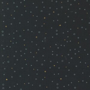 May include: A black background with a scattered pattern of small gold and white circles.
