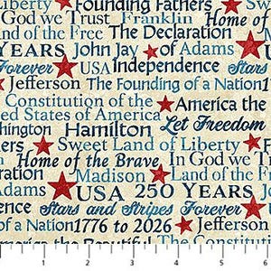 May include: A fabric with a beige background and blue and red text. The text includes phrases like "Liberty," "Founding Fathers," and "USA Independence Stars." Red stars are scattered throughout the design. The fabric commemorates the founding of the United States.