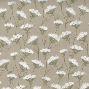 May include: A beige fabric with a repeating pattern of white stylized flowers with green stems and leaves.