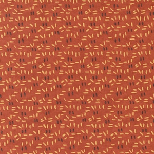 May include: A red fabric with a repeating pattern of small, yellow and black dashes. The fabric has a textured surface.