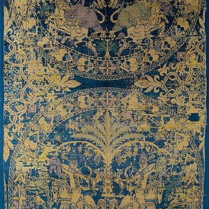 May include: A fragment of a blue and gold silk tapestry featuring a repeating pattern of stylised trees, flowers, and geometric designs. The tapestry is woven with intricate details and features a central motif of a tree with a crown.