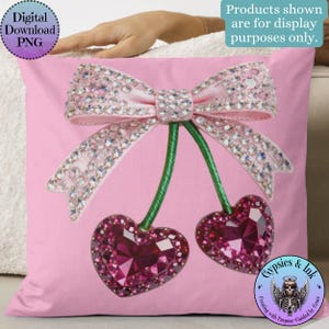 Puede incluir: Cojín decorativo rosa con un gran lazo y dos cerezas en forma de corazón, todos adornados con adornos brillantes. Las cerezas tienen tallos verdes. El cojín tiene el texto "Digital Download PNG".
