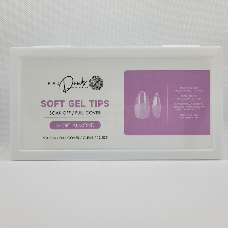 May include: A white box with a pink background containing 504 clear short almond shaped gel nail tips. The box has the text "PAJ Dawb Nail Design" and "Soft Gel Tips Soak Off/Full Cover Short Almond 504 PCS/Full Cover/Clear/12 Size".