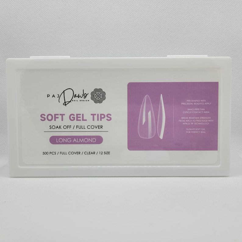 May include: A white plastic container with a purple label that reads "PAJ Dawb Nail Design" and "Soft Gel Tips Soak Off/Full Cover Long Almond 500 PCS/Full Cover/Clear/12 Size". The label also shows two clear long almond shaped nail tips.