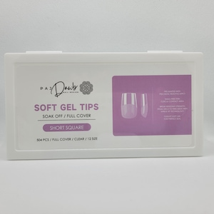 May include: A white box with a pink background containing clear short square soft gel nail tips. The box has the text "PAJ Dawb Nail Design" and "Soft Gel Tips Soak Off/Full Cover Short Square 504 PCS/Full Cover/Clear/12 Size".