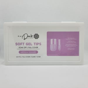 May include: A white box containing clear plastic nail tips labeled "Soft Gel Tips" with the text "Soak Off / Full Cover" and "Medium Square". The box also includes the text "504 PCS / FULL COVER / CLEAR / 12 SIZE".