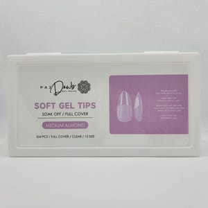 May include: A white box containing 504 clear, medium almond shaped soft gel nail tips. The box has a pink label with the text "PA Dawb Nail Design" and "Soft Gel Tips" in black. The label also says "Soak Off / Full Cover" and "504 PCS / FULL COVER / CLEAR / 12 SIZE".