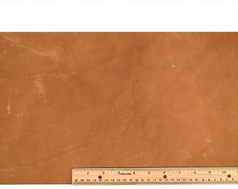 May include: A piece of brown leather with a slightly textured surface. The leather is approximately 12 inches wide and 18 inches long.