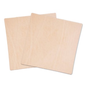 May include: Two pieces of light brown leather, each with a smooth, slightly textured surface. The leather is cut into squares and is ready for crafting projects.