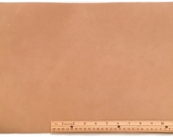 May include: A large piece of light brown leather with a ruler measuring 12 inches along the bottom edge.