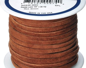 May include: A spool of brown suede leather lace, 1/8 inch wide and 26 yards long. The label reads "REALEATHER Craft Lace" and "SOS25 2002 Suede Lace 1/8" x 26 YD Med. Brown" and "MADE IN THE USA".