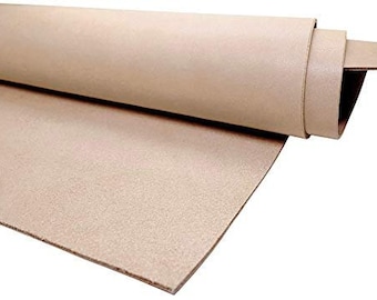 May include: A roll of light brown leather, unbleached and natural, with a smooth, slightly textured surface.