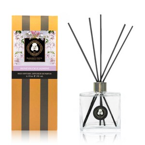 May include: A clear glass bottle with black reeds and a gold lid. The bottle has a label that says "Honeysuckle Jasmine" and "Rainier's Gifts Celebrate Life". The bottle is 6.5 fluid ounces or 192 milliliters.