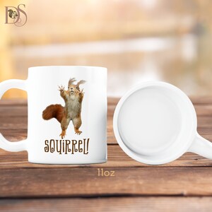 There are two mugs in this photo. One is standing and facing forward showing the design, and the other laying down showing the inside of the mug.