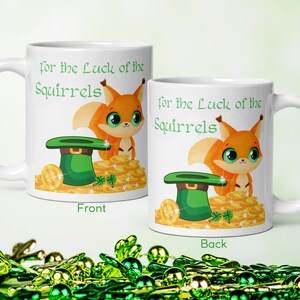 May include: White ceramic mug with a cartoon squirrel and a green leprechaun hat on a pile of gold coins. The text on the mug reads "For the Luck of the Squirrels".