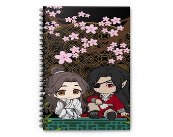 May include: A spiral notebook with a black background featuring two anime characters sitting under a cherry blossom tree. The characters are wearing traditional Chinese clothing. The background is decorated with gold and black geometric patterns.