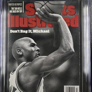 May include: A CGC graded 9.2 Sports Illustrated magazine from February 16, 1998, featuring a black and white photograph of Michael Jordan shooting a basketball. The cover includes the text Sports Illustrated, Winter Olympics, and Don't Bag It, Michael.