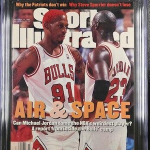 May include: A CGC graded 9.2 Sports Illustrated magazine from October 23, 1995, featuring Dennis Rodman and Michael Jordan on the cover. The cover text reads Air & Space, Why the Patriots don't win, and Why Steve Spurrier doesn't lose.