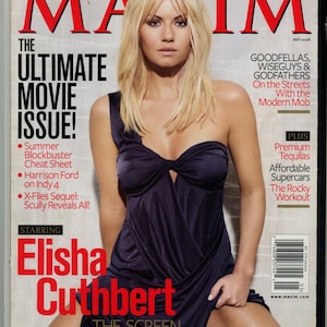 May include: The cover of Maxim magazine, May 2008 issue, features Elisha Cuthbert. The cover has the headline "The Ultimate Movie Issue!" and includes articles on summer blockbusters, Harrison Ford, and the X-Files sequel. The magazine has a red and white color scheme.
