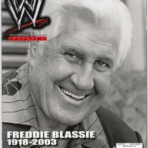 May include: A magazine cover featuring a smiling man with white hair. The magazine is titled "World Wrestling Entertainment Magazine" with the WWE logo. The cover includes the text "FREDDIE BLASSIE 1918-2003" and "Twelve-Page Tribute Inside."
