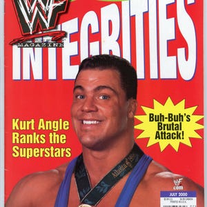 Puede incluir: Una portada de revista roja con Kurt Angle con una medalla de oro. El título "INTEGRITIES" es blanco. El texto incluye "Kurt Angle Ranks the Superstars" y "Buh-Buh's Brutal Attack!" en una estrella amarilla.
