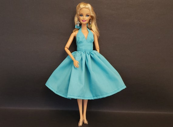 barbie doll design dress Flair for the dramatic. The new Styled by Design Barbie doll was created by Barbie designer Linda Kyaw-Merschon to embody the bold, jaw-dropping red- carpet look of her dreams. Members get