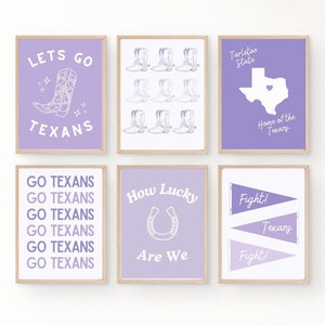 May include: Set of eight purple and white printable wall art prints with Texas themed designs. The prints feature phrases like "Let's Go Texans", "Go Texans", "How Lucky Are We", "Fight! Texans", and "Tarleton State, Home of the Texans".