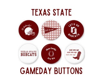 May include: A collection of six Texas State Gameday buttons. The buttons are round and feature maroon and white designs with phrases like "Go Bobcats!" and "Eat 'em up!" The text "TEXAS STATE" and "GAMEDAY BUTTONS" are also displayed.