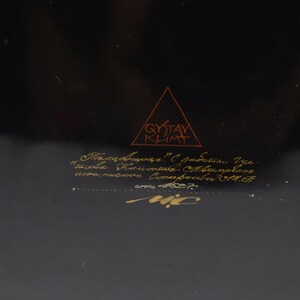 May include: A black background with gold lettering that reads "Gustav Klimt" in a triangle. Below the triangle is more gold lettering that reads "Плавник. 1. Собрание Украинского Фонда Современного искусства.  Киев. 1987."