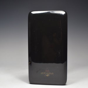 May include: Black rectangular tray with a gold logo and text that reads "The Art of Fine Living" and "Made in China".