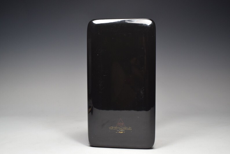 May include: Black rectangular tray with a gold logo and text that reads "The Art of Fine Living" and "Made in China".