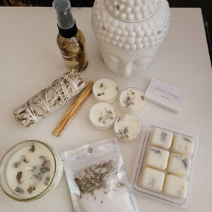 May include: A white ceramic Buddha head diffuser, a white candle, a white wax melt set, a white sage smudge stick, a small bag of white sage and salt, a cinnamon stick, and a bottle of essential oil.