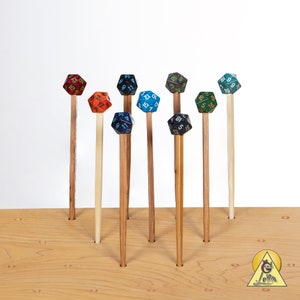 May include: A wooden board with eight holes, each holding a different colored, multi-sided die. The dice are all different colors, including red, blue, green, and black.