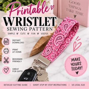 May include: A pink fabric wristlet keychain featuring a black and white paisley pattern attached to a silver metal clasp with a car key and house key. The image includes text: Printable Wristlet Sewing Pattern, Instant Download, and Make Yours Today.