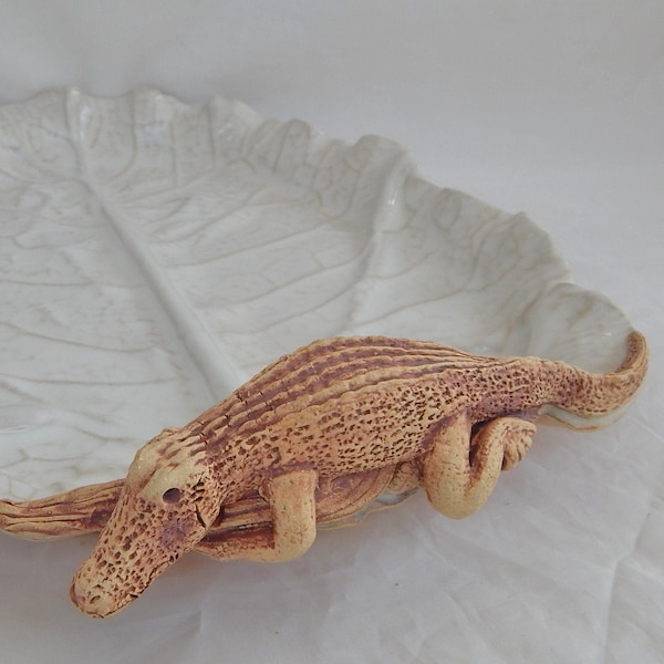 Hand crafted stone ware collard green leaf impression with a gator for a non-slip handle in white glaze.