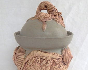 Handmade stoneware large sugar bowl with shells and other sea creatures in matt green glaze.